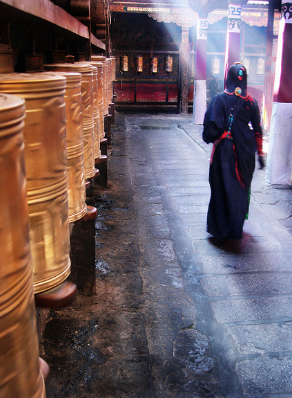 A pilgrim walks the holy kora inside the famous Jokhang Temple, the center of Tibetan Buddhism.